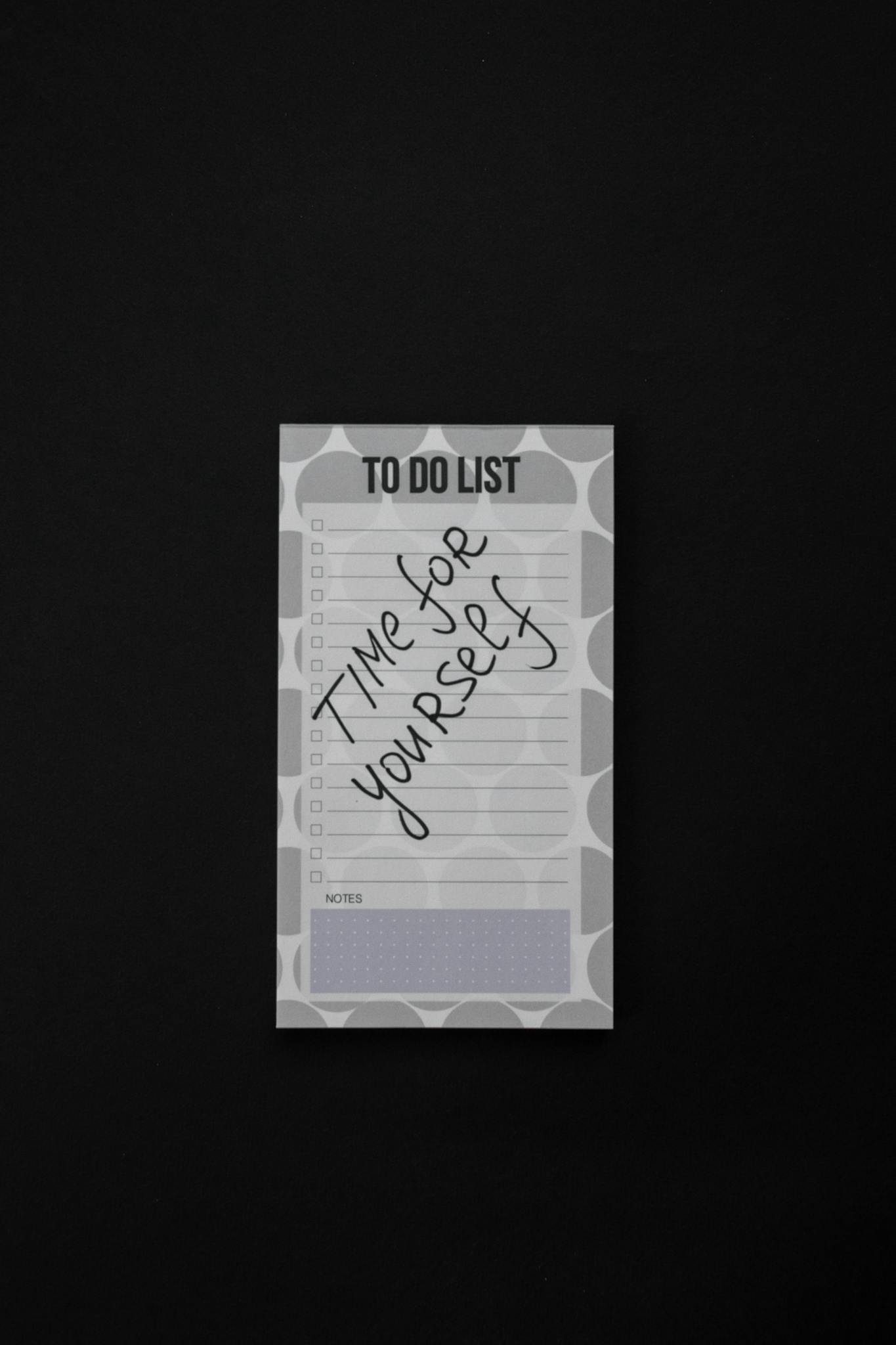 Close-up of a minimalist notepad with a 'Time for yourself' message, ideal for wellness themes.